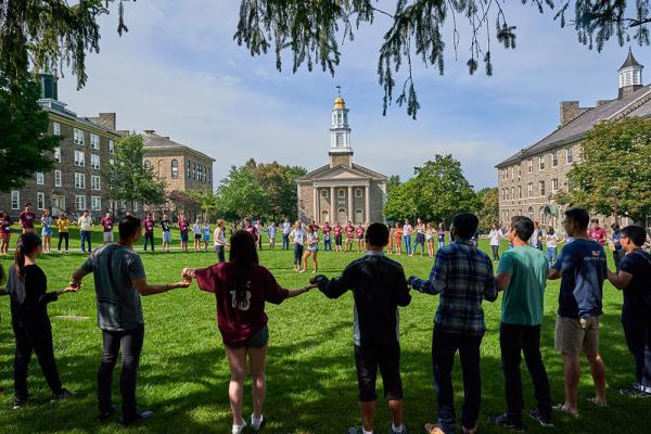Students gathered in a circle on quad in front of chapel