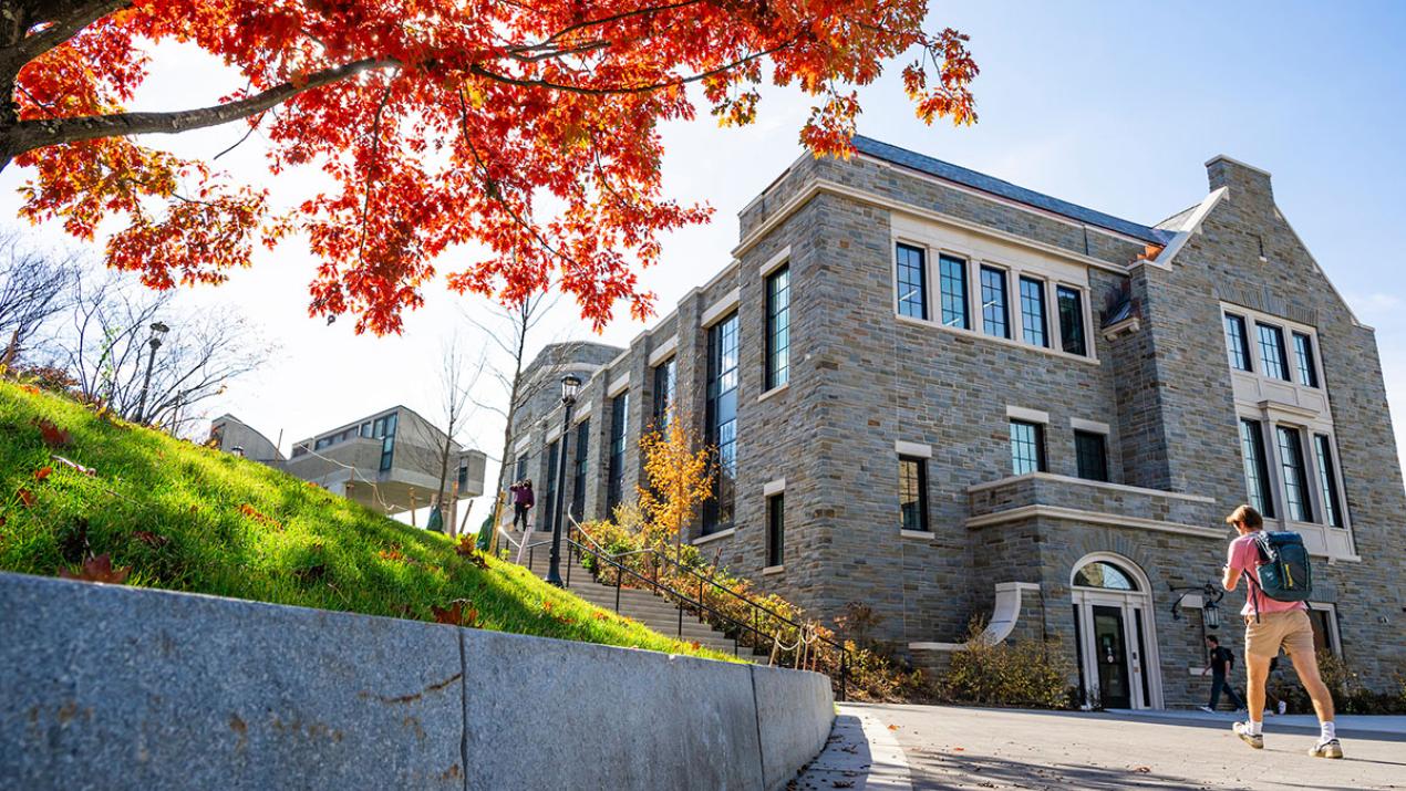 A student walks towards Bernstein Hall 